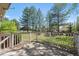 Scenic view from the backyard deck, framed by mature trees and a blue sky at 6803 W Yale Ave, Lakewood, CO 80227