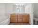 Bathroom showcasing a double sink vanity, tub, and tile flooring at 6803 W Yale Ave, Lakewood, CO 80227