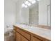 Bathroom with a large mirror, oak vanity, and neutral tile at 6803 W Yale Ave, Lakewood, CO 80227