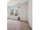 Bright bedroom featuring a large window with views of the lush greenery at 6803 W Yale Ave, Lakewood, CO 80227