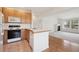 Bright kitchen with wood cabinets, a center island, and modern appliances at 6803 W Yale Ave, Lakewood, CO 80227