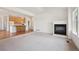 Spacious living area with an open layout, fireplace, and kitchen access at 6803 W Yale Ave, Lakewood, CO 80227