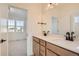 Elegant bathroom with double vanity, large mirror, and modern fixtures at 2670 E 102Nd Pl, Thornton, CO 80229