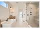 Bright bathroom featuring a modern soaking tub, glass shower, and sleek fixtures at 2670 E 102Nd Pl, Thornton, CO 80229