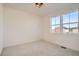 Cozy bedroom with abundant natural light from two windows and plush carpeting at 2670 E 102Nd Pl, Thornton, CO 80229