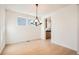 Contemporary dining area featuring wood floors, chandelier, and natural light at 2670 E 102Nd Pl, Thornton, CO 80229