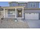 Welcoming two-story home featuring a cozy front porch and attached garage at 2670 E 102Nd Pl, Thornton, CO 80229