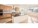 Sunlit kitchen featuring an island with granite countertops and stainless steel appliances at 2670 E 102Nd Pl, Thornton, CO 80229