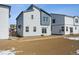 Exterior of home with sliding glass doors in the backyard with snow on the ground at 19088 E 94Th Pl, Commerce City, CO 80022