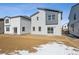 Exterior of home with sliding glass doors in the backyard with snow on the ground at 19088 E 94Th Pl, Commerce City, CO 80022