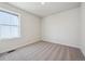 This cozy bedroom features plush carpeting and a large window providing lots of natural light at 19088 E 94Th Pl, Commerce City, CO 80022