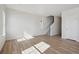 Bright living room with wood floors, fresh white paint and trim, and staircase leading to the second floor at 19088 E 94Th Pl, Commerce City, CO 80022