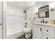 Clean bathroom with a shower-tub combo, vanity with black hardware, and black mosaic tile flooring at 5396 Bear Mountain, Evergreen, CO 80439