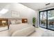 Serene bedroom featuring a private balcony with lovely nature views and cozy decor at 5396 Bear Mountain, Evergreen, CO 80439