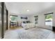 Bright bedroom with an area for a study, three windows, and a patterned rug at 5396 Bear Mountain, Evergreen, CO 80439