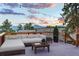 Enjoy outdoor living on this deck with comfortable seating and mountain views at sunset at 5396 Bear Mountain, Evergreen, CO 80439