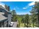 Relax on this spacious deck offering spectacular views of the lush landscape and blue skies at 5396 Bear Mountain, Evergreen, CO 80439