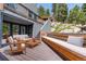 Relaxing outdoor deck space with comfortable seating, wooded views, and bench seating at 5396 Bear Mountain, Evergreen, CO 80439