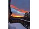 An expansive deck shows gorgeous mountain views and a beautiful sunset over the peaks at 5396 Bear Mountain, Evergreen, CO 80439