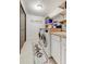 Laundry room featuring a side-by-side washer and dryer, wooden countertop, and shelving for storage at 5396 Bear Mountain, Evergreen, CO 80439