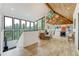 Open-concept living room with a dining area featuring floor-to-ceiling windows and a striking wood ceiling at 5396 Bear Mountain, Evergreen, CO 80439