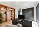 Bright home office with custom wood bookshelf, a black desk and ample natural light at 5396 Bear Mountain, Evergreen, CO 80439