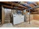 Unfinished basement with washer and dryer and exposed plumbing at 374 S Lincoln St, Denver, CO 80209