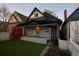 Charming bungalow with a cozy front porch and a well-manicured lawn at 374 S Lincoln St, Denver, CO 80209