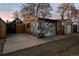 Detached garage with a concrete driveway featuring cartoonish graffiti art on the exterior at 374 S Lincoln St, Denver, CO 80209