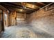 Interior of a detached garage featuring exposed brick walls, concrete flooring, overhead lighting and ample storage at 374 S Lincoln St, Denver, CO 80209