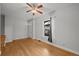 Bright living room featuring hardwood floors, a ceiling fan, and natural light at 374 S Lincoln St, Denver, CO 80209