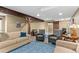 Spacious basement featuring comfortable seating, wooden support beams, and luxury vinyl flooring at 2429 S Orchard St, Lakewood, CO 80228