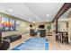 Finished basement featuring a cozy seating area, wooden beams, and ample lighting at 2429 S Orchard St, Lakewood, CO 80228