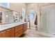 This bathroom features double sinks, modern cabinetry and a glass shower at 2429 S Orchard St, Lakewood, CO 80228