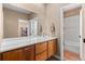 Bathroom featuring a double vanity with wood cabinetry and a large mirror at 2429 S Orchard St, Lakewood, CO 80228