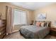 Comfortable bedroom with a plush queen bed, neutral decor, and soft, natural light at 2429 S Orchard St, Lakewood, CO 80228