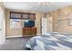 A cozy bedroom with a wooden dresser, a ceiling light and windows at 2429 S Orchard St, Lakewood, CO 80228