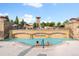 Relaxing community pool with a waterfall feature and attractive stone architecture on a sunny day at 2429 S Orchard St, Lakewood, CO 80228