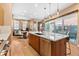 Open kitchen with island seating and stainless appliances connects the living areas at 2429 S Orchard St, Lakewood, CO 80228