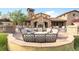 Inviting outdoor patio featuring comfortable seating around a cozy fireplace at 2429 S Orchard St, Lakewood, CO 80228