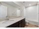 Well-lit bathroom with large mirror, single sink, and a shower-tub combo at 14400 Heritage Dr, Mead, CO 80504