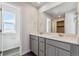 Bathroom featuring a double vanity, a large mirror, and ample lighting at 14400 Heritage Dr, Mead, CO 80504
