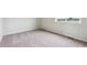 Neutral carpet bedroom with window view of houses at 14400 Heritage Dr, Mead, CO 80504