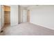 Carpeted bedroom featuring adjoining closet and doorway at 14400 Heritage Dr, Mead, CO 80504