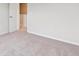 Neutral bedroom with soft carpet, white walls, and a doorway leading to another room at 14400 Heritage Dr, Mead, CO 80504