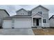 Charming two-story home showcasing a three-car garage, neutral siding, and a welcoming covered entry at 14400 Heritage Dr, Mead, CO 80504