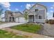 Charming two-story home featuring a two-car garage, manicured lawn, and welcoming entrance at 14400 Heritage Dr, Mead, CO 80504