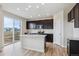 Modern kitchen featuring sleek black cabinetry, a center island, and stainless steel appliances at 14400 Heritage Dr, Mead, CO 80504