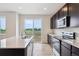 Modern kitchen features stainless steel appliances, an island with sink, and a sliding glass door at 14400 Heritage Dr, Mead, CO 80504