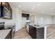 Modern kitchen features stainless steel appliances, an island with sink, and hard wood floors at 14400 Heritage Dr, Mead, CO 80504